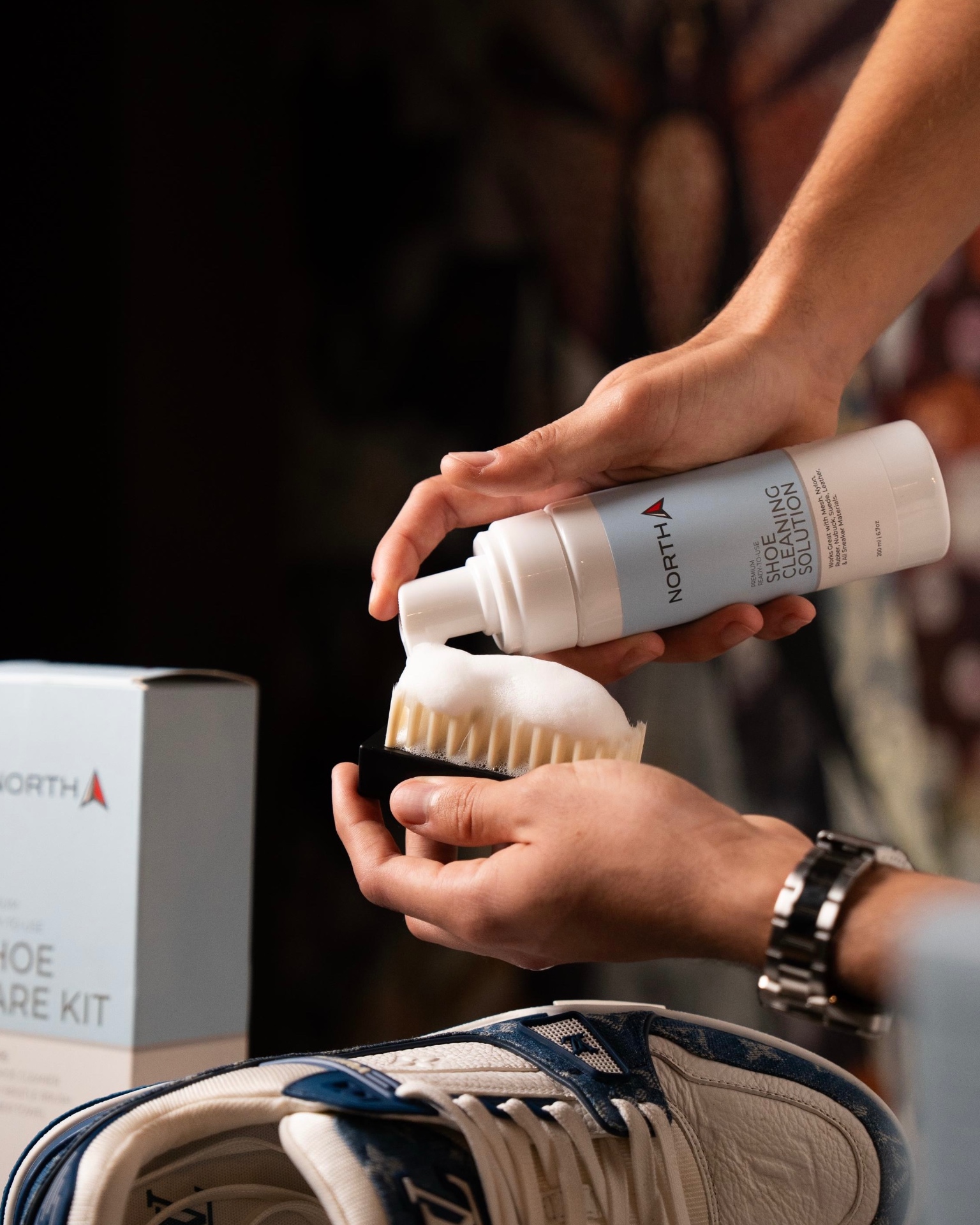 Applying North foaming shoe cleaner to the North brush